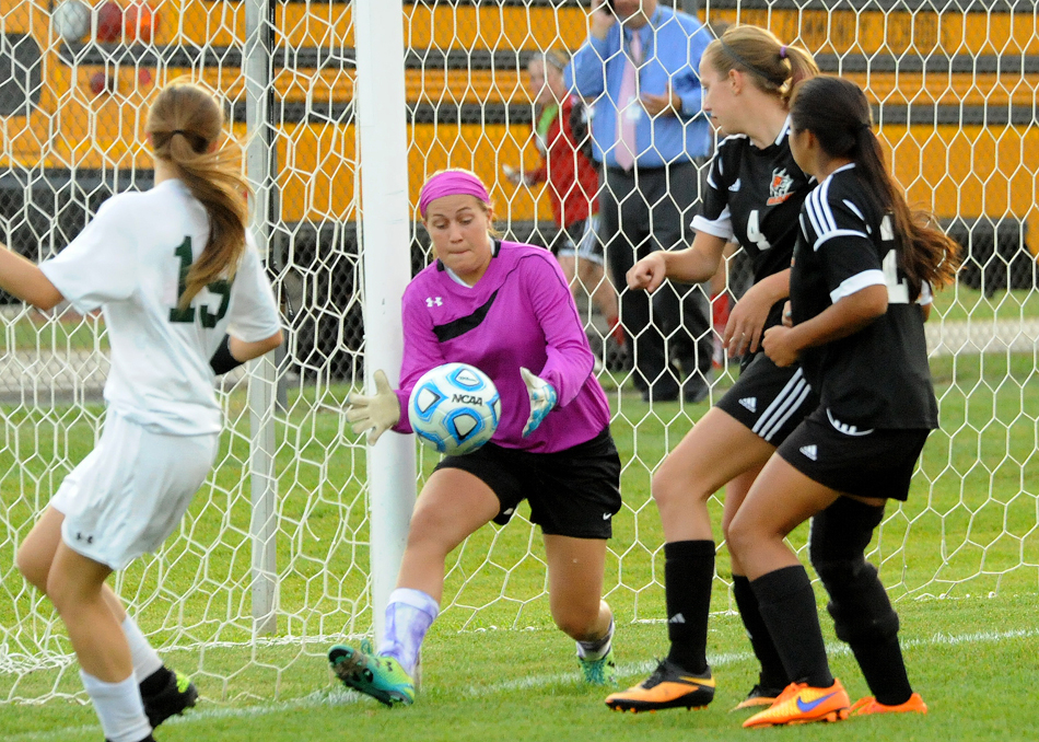 Wawasee goalkeeper Kayla White emerges with the ball in front of heavy Warsaw pressure.