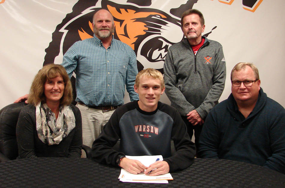 Warsaw Community High School senior Owen Glogovsky has signed a letter of intent to continue his cross country and track career at Lipscomb University. Seated with Owen are parents Jan and Terry Glogovsky. In the back row are WCHS athletic director Dave Anson and WCHS boys cross country coach Jim Mills. (Photo provided)