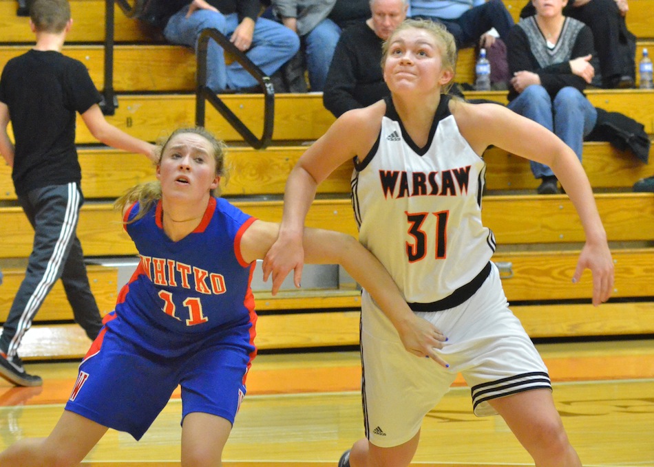 Emily Day (11) and Kacy Bragg (31) battle for position after a free throw in Whitko's 50-28 win over Warsaw Friday night. Friday's game was Bragg's first career start for the Lady Tigers. (Photos by Nick Goralczyk)