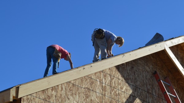 Caleb Bolt, left, and Alan Bontrager work on the roof of a house being built in Elkhart County. The two are Wawasee building trades students.