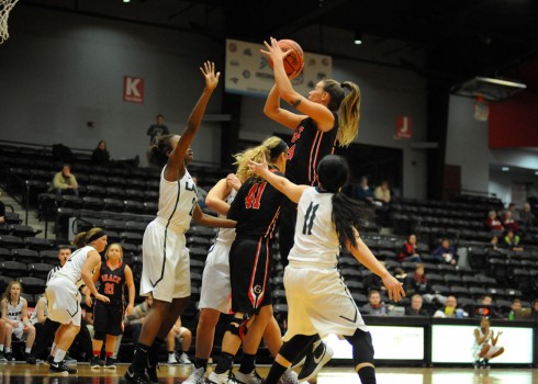 Haley Richardson shoots in a crowd of Roosevelt defenders.
