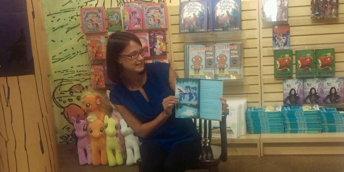 Joy Hill reads from her new book to some young fans.