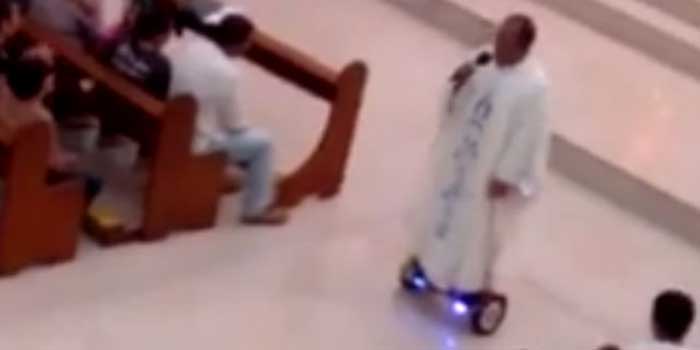 The priest riding his hoverboard during Mass