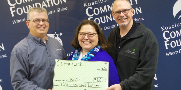 Suzie Light, Kosciusko County Community Foundation Executive Director (middle), accepts a donation from CenturyLink representatives Rob Parker, Area Plant Supervisor (left), and Ted Madden, Area Operations Manager (right).
