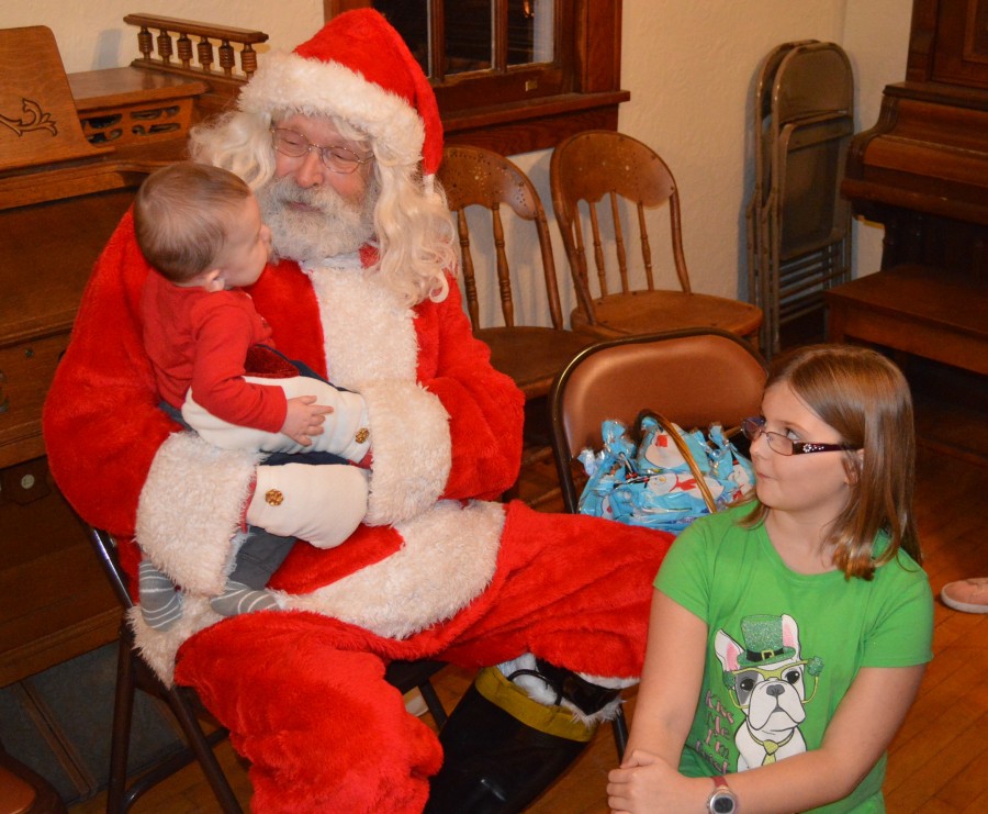 Allison Barrett watches as her brother, Toby Barrett, gave his Christmas wish list to Santa at Leesburg Town Hall. The siblings are the children of Tim and Cassandra Barrett.