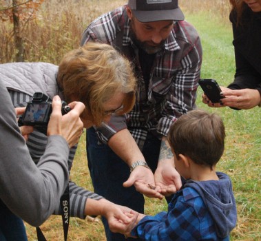 Young Ian Claxton examines toads found in Claxton Woods. Shown from the left, are: Laura (Claxton) Troyer, Martha (Claxton) Coffing, Chris Claxton, Jaime Claxton. (Center): Ian Claxton.