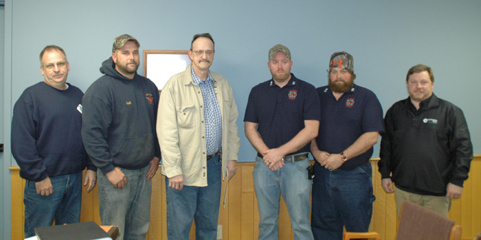 Tim Miller of Milford, third from left, suffered a heart attack just before 8 a.m. Oct. 26, but thanks to the efforts of emergency medical personnel he was successfully resuscitated. Scott Sigurfoos and Millie Bartley of Lutheran EMS Kosciusko were at Milford’s Town Council meeting to recognize, from left, Rodney Bray, Scott Mast, Chad Veach, Corey Veach of the Milford Fire Department and paramedic Steve Stokes of Lutheran EMS. Others not present were, from Milford Fire Department Rob Brooks, Steve Farber, Troy Haines, Dan Duncan, Kevin Walker, Virgil Sharp and Brian Haines, paramedics Hannah Young, Darrell Sopher and advanced EMT Kim Miller. (Photo by David Hazledine)