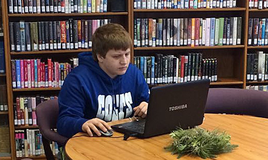 : Karlan Miller uses his laptop on the wifi at Milford Public Library. The library has internet for use on your phone, computer, and on our computers for you to come in and use. Ask us about our internet and we can get you set up! 