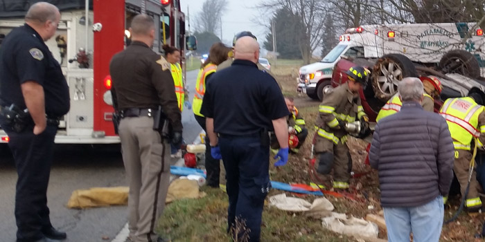 Crews work to free a driver after a rollover accident on Pierceton Road Saturday morning. (Photos by Amanda McFarland)