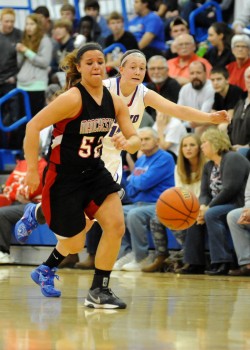 Manchester's Cierra Carter chases after a loose ball with Whitko's Aly Reiff in pursuit.