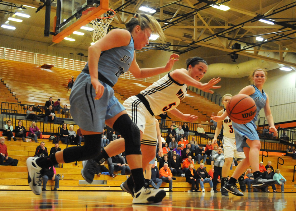 Warsaw's Page Desenberg and South Bend St. Joe's Nicole Konieczny hustle for a loose ball during the championship game of the Warsaw TCU Lady Tiger Classic Tuesday night. (Photos by Mike Deak)