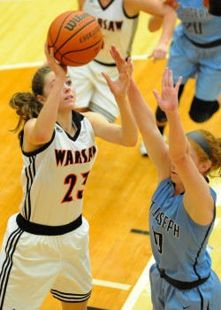 Warsaw's Dayton Groninger puts up a shot over St. Joe's Brooke Juday.