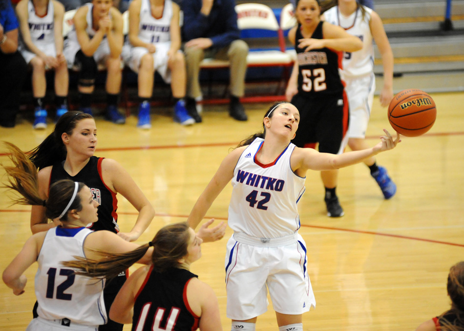 Whitko's Kennedy Krull gets a hand on a rebound Friday night in a 57-29 win against Manchester. (Photos by Mike Deak)