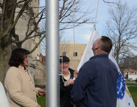Diane Wulliman, county coordinator and Bob Conley, county commissioner, work with Steve Amburgy, county courthouse maintenance, to raise the bicentennial flag. (Photos by Deb Patterson)