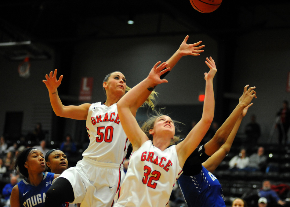 Grace College's Haley Richardson (50) and Sarah Feasby battle for a rebound Wednesday night against St. Francis. (Photos by Mike Deak)