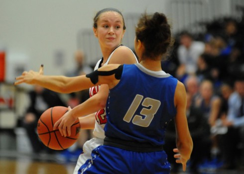 Grace guard Kelsey Sule looks for a teammate while St. Francis' Zhanna Chukhrii defends.