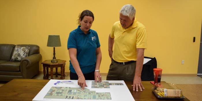 Pictured from left are Beaman executive director Tracie Hodson and Warsaw Police Department officer and K21 Health Foundation director Joe Hawn, reviewing safety designs for Beaman Home. (Photo provided)