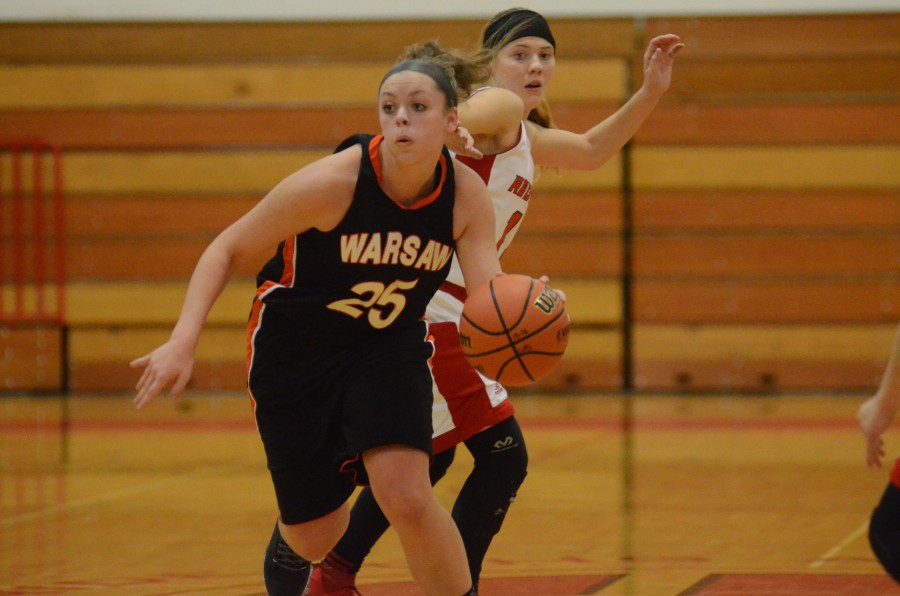 Madi Graham heads up the court for Warsaw Saturday night at Goshen. Graham helped the Tigers rally for a 37-33 NLC win.