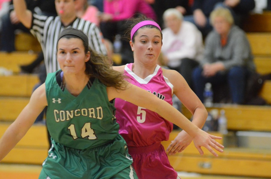 Page Desenberg reacts as she tries to get in rebounding position with Concord's Nicki Wilhelm Saturday night. Desenberg exploded for 22 points to lead Warsaw to a dominating win.