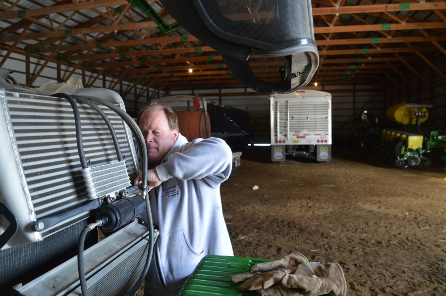 Bruce Ferguson maintaining a farm tractor
