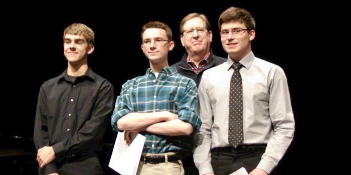 2015’s winners of the Young Artist Competition stand with Chair of the Symphony of the Lakes Committee Mike Gavin. From left, are: Ben Meulink, Drew Tomasik, Mike Gavin, and David Zoschnick. (Photo credit: Terry White)