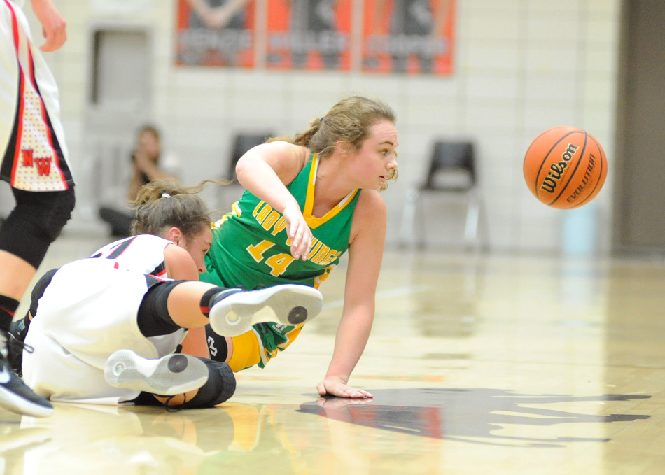 Tippecanoe Valley's Meredith Brouyette chases down a loose ball as NorthWood's Taitlyn Trenshaw takes a spill.
