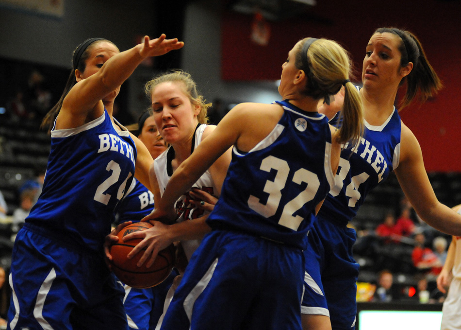 Grace College's Sarah Feasby is surrounded by Bethel's Ashley Lutz (24), Macie Hinen (32) and Savannah Bley (34) during Saturday afternoon's contest at Grace. (Photos by Mike Deak)