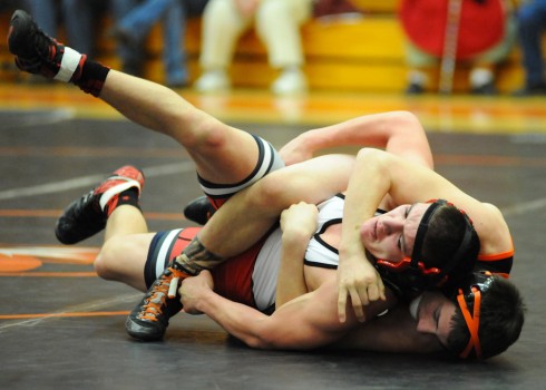 Warsaw's Kyle Hatch pulls in Goshen's Noah Shively en route to a pin at 145.