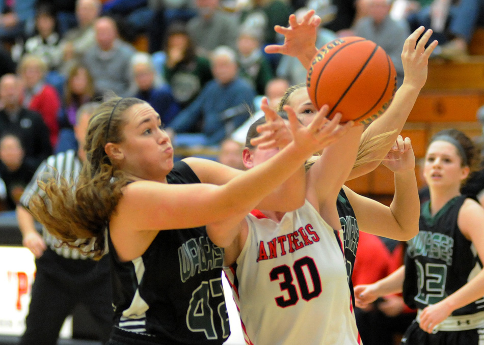 Wawasee's Aubrey Schmeltz works for a rebound against NorthWood's Savannah Feenstra Saturday night during the Panthers' 32-25 win. (Photos by Mike Deak)