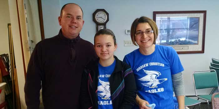 ohn Weirick, 6th grader Hannah Weirick, and Val Weirick serving together. 