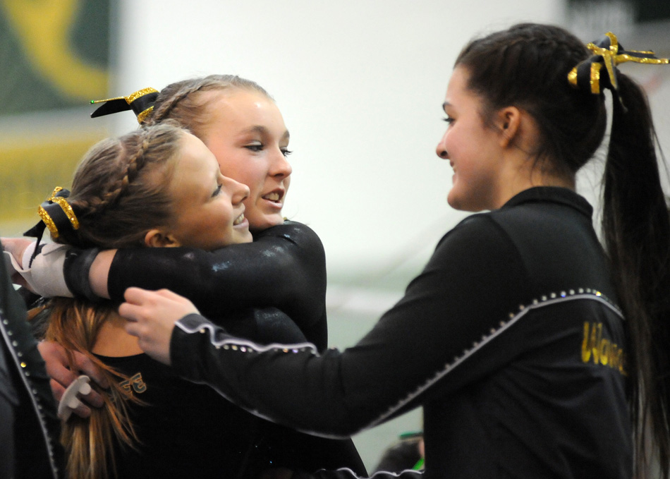 Wawasee's Reagan Atwood hugs teammate Alyssa Minnix as Tamara Bruder closes in. Wawasee celebrated its first team regional appearance in seven years after placing second at Saturday's Wawasee Gymnastics Sectional. (Photos by Mike Deak)