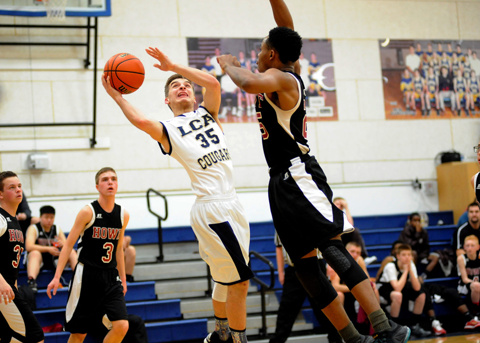 Carter Twombly slices to the hoop as Howe's Eric Robinson closes in.