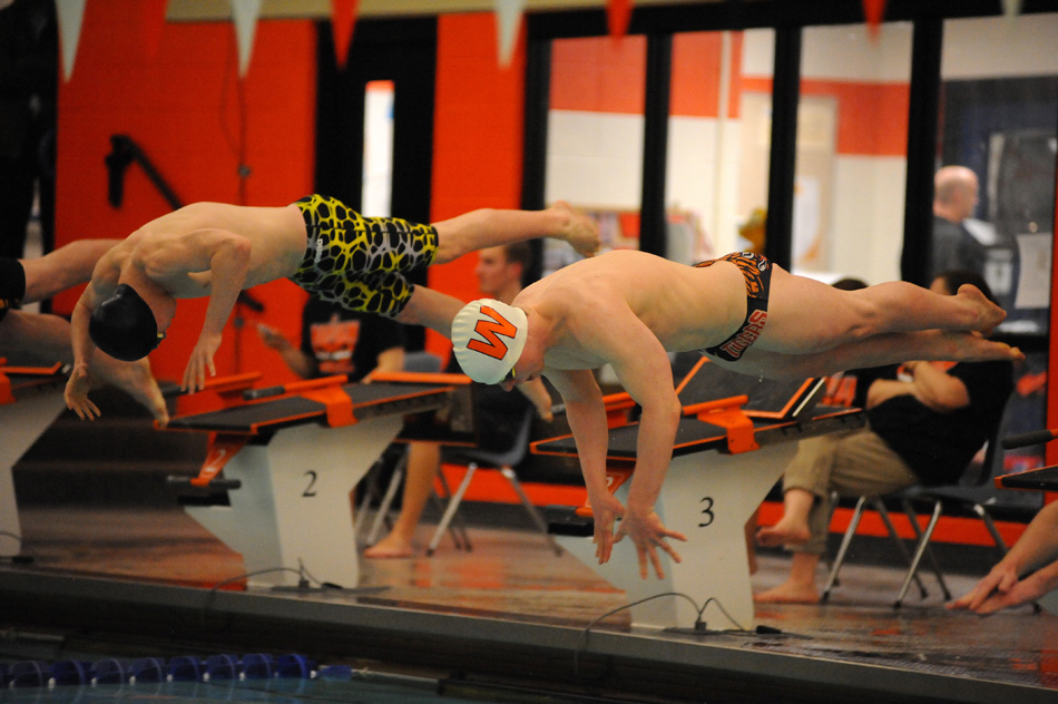 Brothers Alex (left) and Ethan Cook take off in the 50 freestyle prelims at Thursday's Warsaw Boys Swimming Sectional.