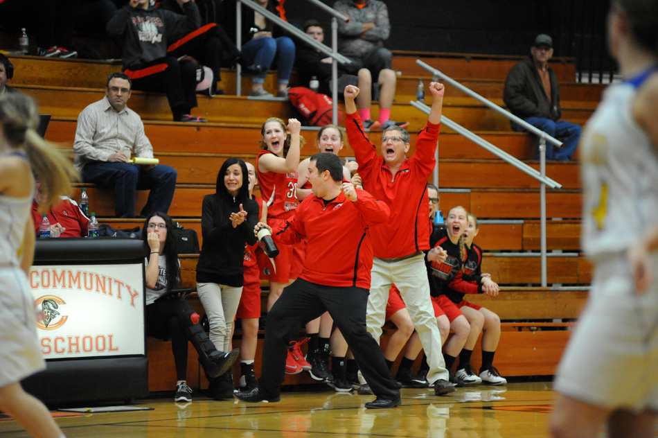 North Miami head coach Ryan DeMien, center, celebrates with several excited Warriors after Triton turned the ball over in the final seconds of North Miami's 31-29 come-from-behind win Tuesday night at the Culver Girls Basketball Sectional. (Photos by Mike Deak)