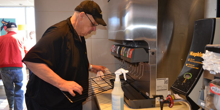James Sweet, McDonald's employee, cleans a beverage fountain. (Photos by Amanda McFarland