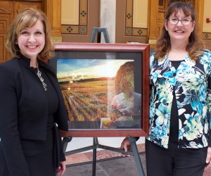 State Treasurer Kelly Mitchell is shown with Kristen Shriver and her artwork, “Rolling Out The Harvest.” This is the second year in a row that Shriver has been recognized as a Hoosier Women Artists. (Photo provided)