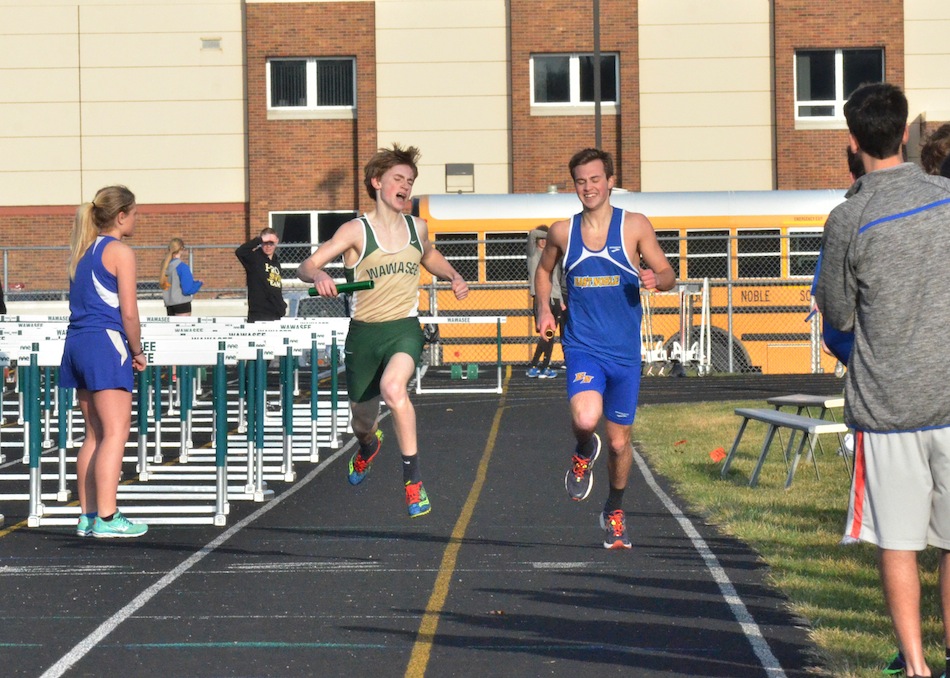Luke Griner (left) gets by Joe Vandiver to win the 4x800 relay for Wawasee. 