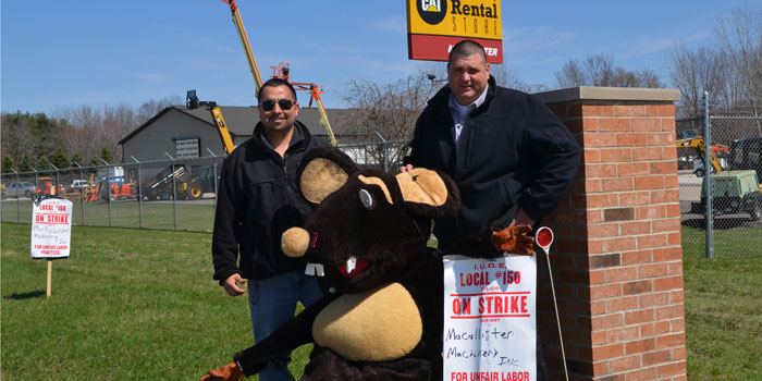 Fred Alvarez, left, and Brad Milliken pose with "Cheesy" during a strike of the Operating Engineers Local 150 labor union. (Photo by Amanda McFarland)