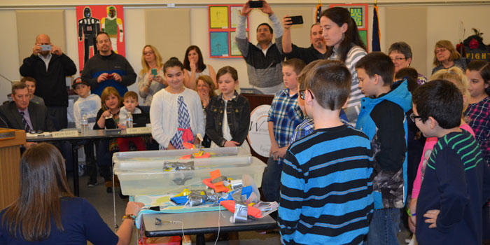 Teachers, parents and school board members watch as Lincoln Elementary School fourth-graders demonstrate a slow boat race. (Photos by Amanda McFarland)