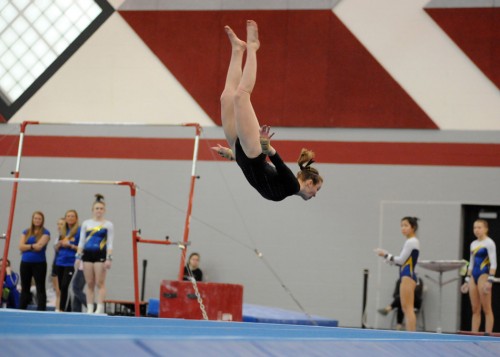 Reagan Atwood of Wawasee sails on a tumbling pass during her floor routine.