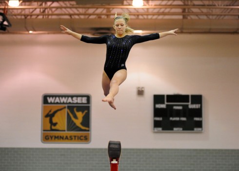 Wawasee freshman Alyssa Minnix soars off the beam during her routine last Saturday at the Wawasee Gymnastics Sectional. (Photos by Mike Deak)