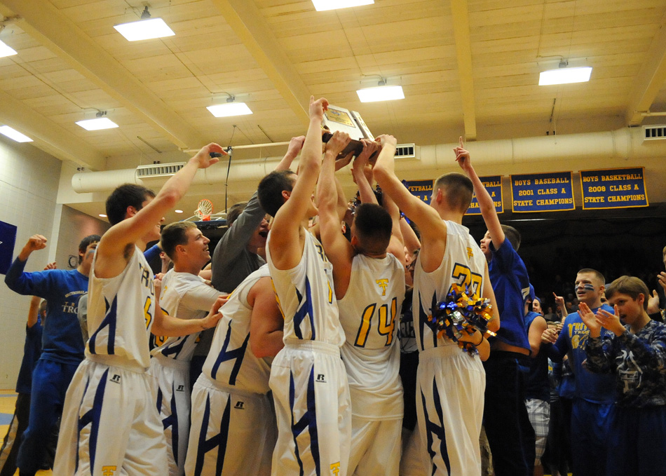Triton raises its 12th sectional championship trophy after beating Oregon-Davis, 55-36, Saturday night at the Triton Boys Basketball Sectional. (Photos by Mike Deak)