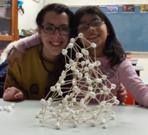 Grace College Student Rachel Brown and a first grade student building marshmallow tower during College Mentors of Kids program. (Photo provided)