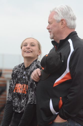 Warsaw senior Sarah Shoemaker shares a laugh with Kim Shoemaker Friday night. Shoemaker organized the Wounded Warrior Project Game to honor and support local veterans. The host Tigers rallied to beat Concord 12-11 in the NLC contest.