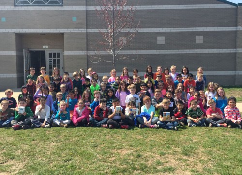 First graders from Harrison Elementary School show off food items they plan to donate to the Boomerang Backpack program as part of a field trip to Martin's Supermarket