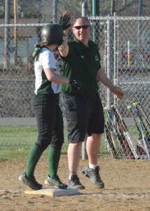 Wawasee assistant coach Kenny Gunkel high fives his daughter, Danielle, after she knocked in the go-ahead run in Friday's win over Manchester. (Photos by Nick Goralczyk)