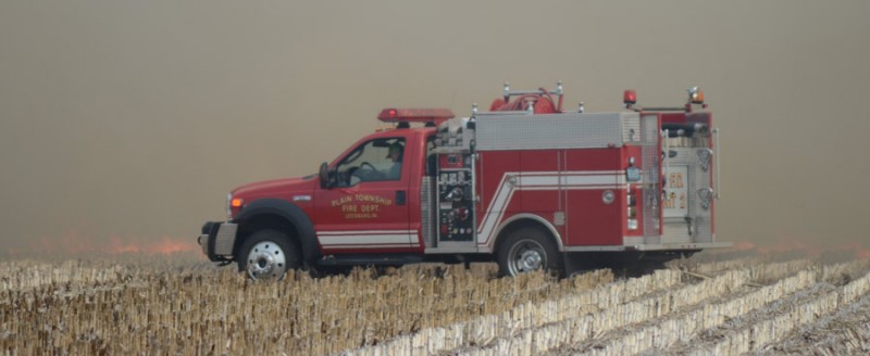 Firefighters in a Plain Township Grass truck head out to extinguish the fire. (Photos by Deb Patterson)