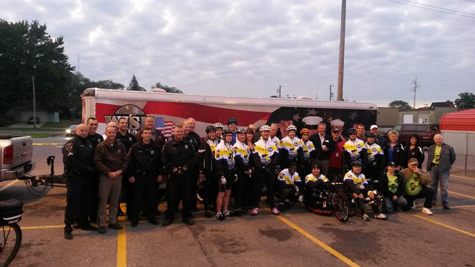 Local cyclists, officers, Mayor Joe Thallemer and the Ride Indiana team from the 2014 Ride Indiana visit Warsaw. (Photo provided) 