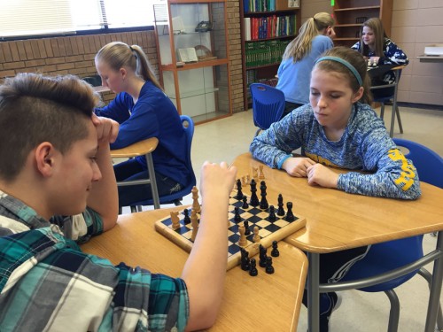 Dylan Fear and Megan Lindsey face off during a chess game in their pre-algebra class