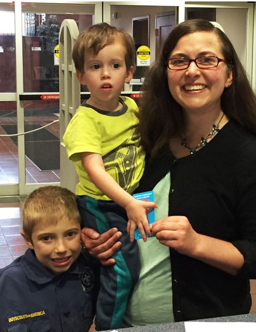 New Children's Librarian, Katie Warrener, signs up for her WCPL library card while accompanied by her nephews Kevin and Henry Gough. 